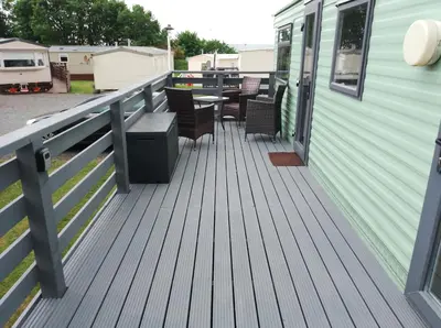 a deck with chairs and a table on a trailer at Cairnryan - Loch Ryan View in Cairnryan