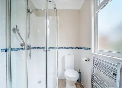 a bathroom with a toilet and a glass shower at Picturesque beauty of Strachur in Strachur