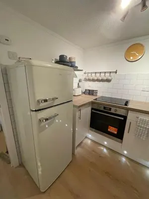 a kitchen with a white refrigerator and a stove at Largs 2 bedroom Apartment in Largs