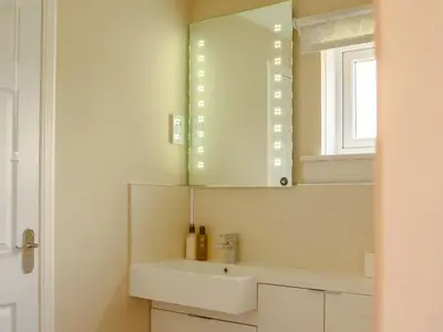 a bathroom with a white sink and a mirror at Cairnies - Uk47886 in Keilour