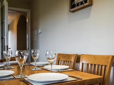 a wooden table with wine glasses and plates on it at Cairnies - Uk47886 in Keilour