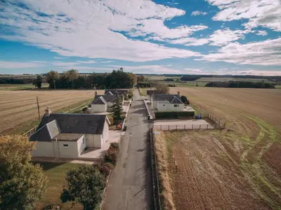 an aerial view of a farm with houses and a field at Langside - Uk47885 in Keilour