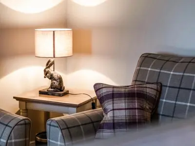 a room with two chairs and a lamp on a table at Lochy - Uk47884 in Keilour