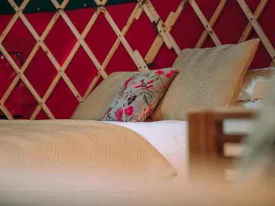 a bedroom with a bed with pillows on it at Timothy Yurt - Uk47889 in Keilour
