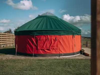 a green and red tent in the grass at Timothy Yurt - Uk47889 in Keilour