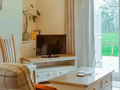 a living room with a flat screen tv on a dresser at Ninetrees - Uk47883 in Keilour