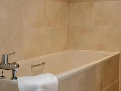 a bath tub in a bathroom with a towel on it at Ninetrees - Uk47883 in Keilour