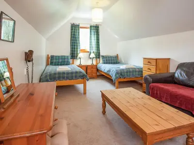 a living room with a couch and a table at Bidean Cottage - Uk41933 in Glencoe