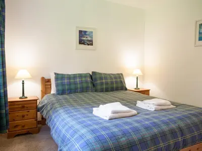 a bedroom with a bed with two towels on it at Bidean Cottage - Uk41933 in Glencoe
