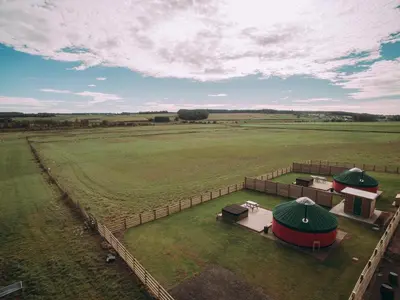 an aerial view of a large green field with tents at Moss Yurt - Uk47888 in Keilour
