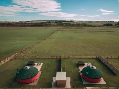 an aerial view of a field with two picnic tables at Moss Yurt - Uk47888 in Keilour