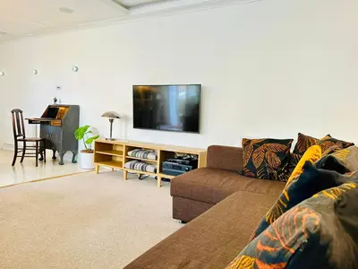 a living room with a couch and a flat screen tv at Crieff Armoury in Crieff