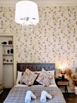 a bedroom with a bed with two slippers on it at No15 Castle View in Edinburgh