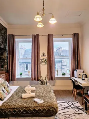 a bedroom with a bed with a teddy bear on it at No15 Castle View in Edinburgh