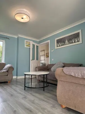 a living room with a couch and a table at Glasgow Central guest house free parking in Govan