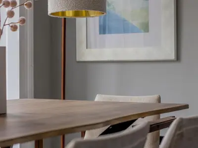 a dining room table with chairs and a lamp at Spacious Hillhead Haven - Pass the Keys in Glasgow