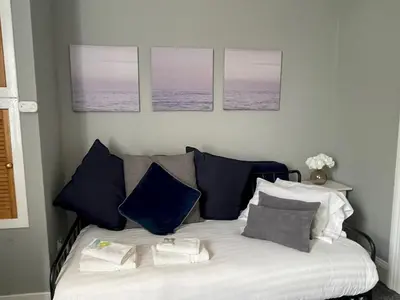 a bedroom with a bed with blue and white pillows at Spacious Hillhead Haven - Pass the Keys in Glasgow