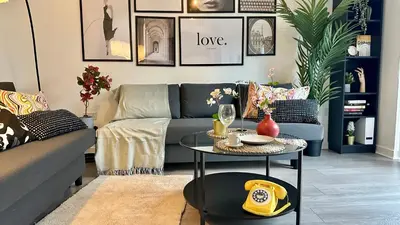 a living room with a couch and a table at Newbuild Riverview 3BDR House near Glasgow in Dalmuir