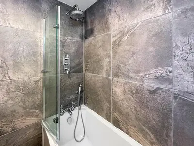 a bathroom with a shower and a bath tub at Fin Glen in Killin