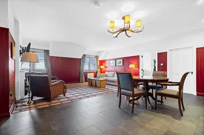 a living room with a dining room table and chairs at Ugadale Cottages in Machrihanish
