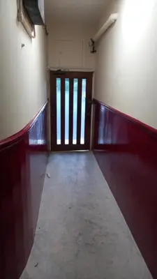 an empty room with a door and a room with a hallway at Snug - Grian-aig Apartment in Greenock