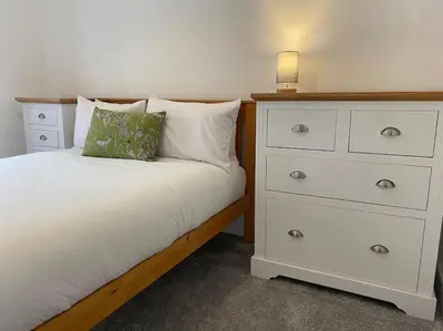 a bedroom with a white dresser and a bed at 3 Smithhills Paisley central spacious sleeps 4 in Paisley