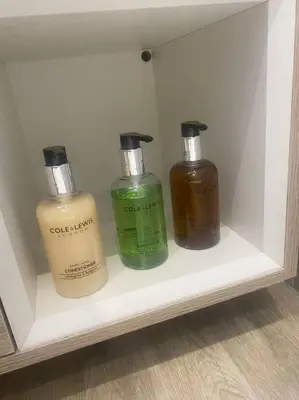 three bottles of soap are sitting on a shelf at 3 Smithhills Paisley central spacious sleeps 4 in Paisley
