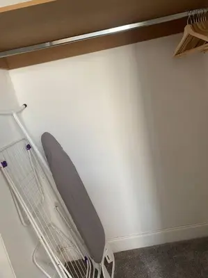 a metal rack in a room with a white wall at 3 Smithhills Paisley central spacious sleeps 4 in Paisley