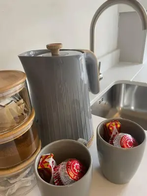 two cups on a counter next to a kitchen sink at 3 Smithhills Paisley central spacious sleeps 4 in Paisley