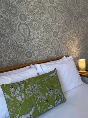a bedroom with a bed with a green and white pillow at 3 Smithhills Paisley central spacious sleeps 4 in Paisley