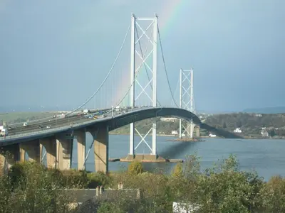 a bridge over the water with cars on it at Carnegie Holiday Cottage in Dunfermline