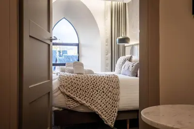 a hotel room with a bed and a window at Arran Shores Luxury Shorefront Apartment 2 in Lamlash