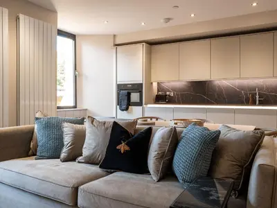 a living room with a couch with pillows at Arran Shores Luxury Shorefront Apartment 2 in Lamlash