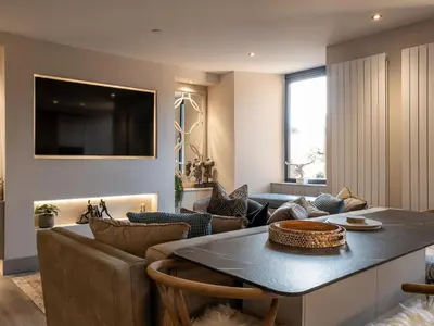 a living room with a couch and a table with chairs at Arran Shores Luxury Shorefront Apartment 2 in Lamlash