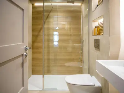 a bathroom with a shower and a toilet and a sink at Arran Shores Luxury Shorefront Apartment 3 in Lamlash