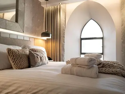 a bedroom with a large bed with a large window at Arran Shores Luxury Shorefront Apartment 3 in Lamlash