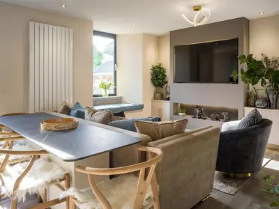 a kitchen and living room with a table and chairs at Arran Shores Luxury Shorefront Apartment 4 in Lamlash