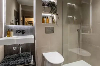 a bathroom with a shower and a toilet and a sink at Arran Shores Luxury Shorefront Apartment 4 in Lamlash