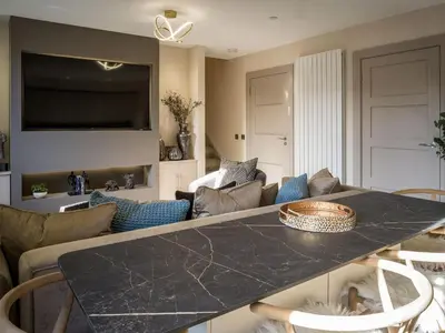 a kitchen and living room with a black counter top at Arran Shores Luxury Shorefront Apartment 4 in Lamlash