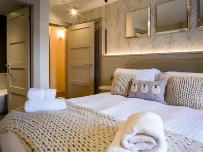 a bedroom with a bed with towels on it at Arran Shores Luxury Shorefront Apartment 5 in Lamlash