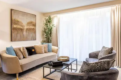 a living room with a couch and a table at Arran Shores Luxury Shorefront Garden Terrace Apartment 6 in Lamlash