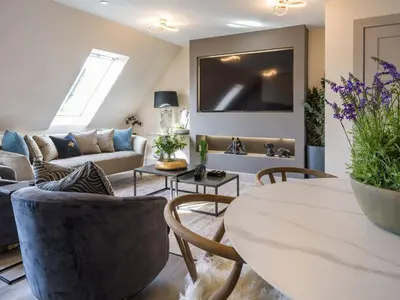 a living room with a couch and a table at Arran Shores Luxury Shorefront Apartment 14 in Lamlash
