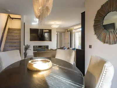 a dining room and living room with a table and chairs at Arran Shores Luxury Shorefront Suite 1 in Lamlash