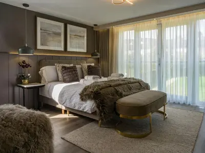 a bedroom with a large bed with a large window at Arran Shores Luxury Shorefront Apartment 8 in Lamlash