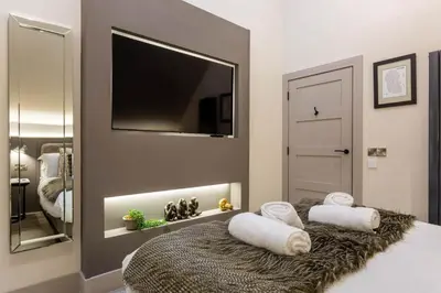 a bedroom with a bed with two pillows on it at Arran Shores Luxury Shorefront Penthouse Suite 13 in Lamlash