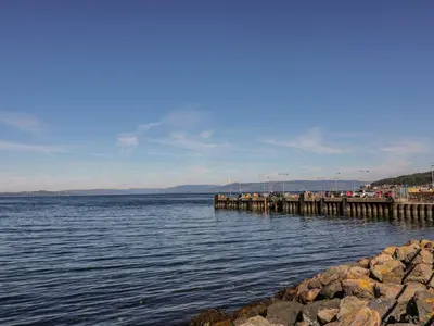 a large body of water with a pier at 8 George Street in Millport