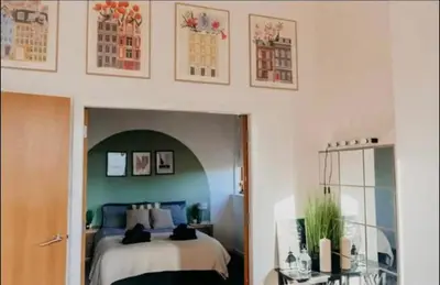 a bedroom with a bed with blue and white at Glasgow City Centre Apartment in Glasgow