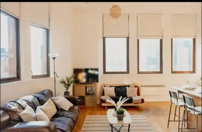 a living room with a couch and a table at Glasgow City Centre Apartment in Glasgow