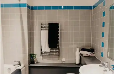 a bathroom with a sink and a toilet and a tub at Glasgow City Centre Apartment in Glasgow