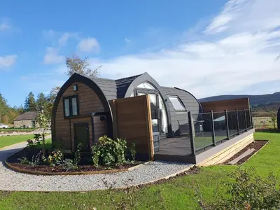 a small house with a fence around it at East Rigg Lodges in Balerno
